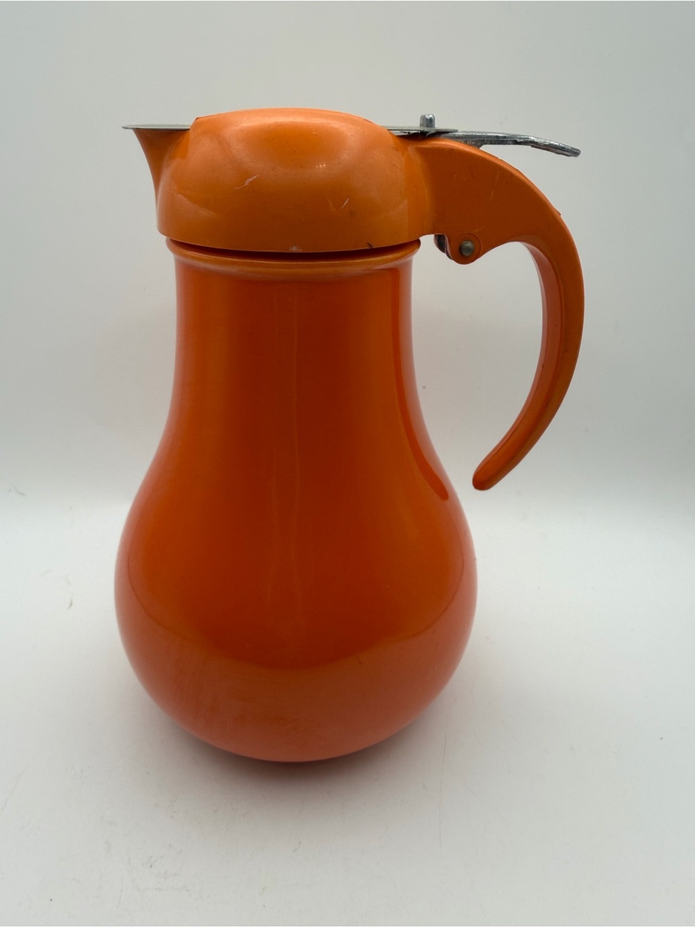 Rare vintage orange Fiesta syrup dispenser featuring a metal Dripcut lid